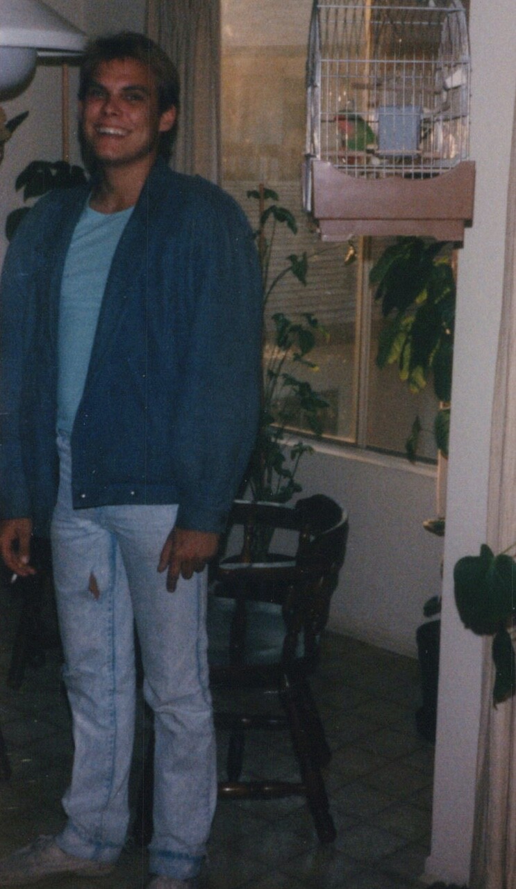 Candid Portrait Handsome Young Man in Jacket Smiling Indoors 1980s