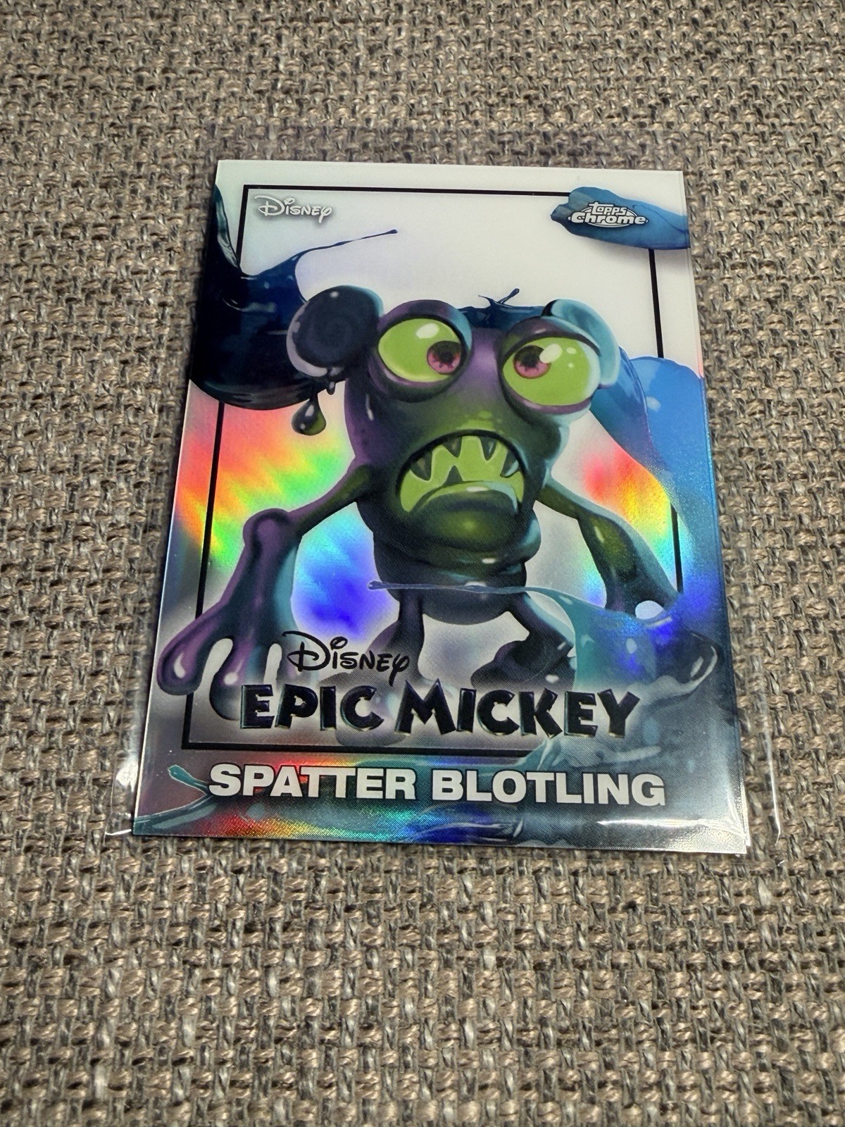 [EM-18] Epic Mickey “Spatter Blotling” (2026 Topps Disney Neon Insert)