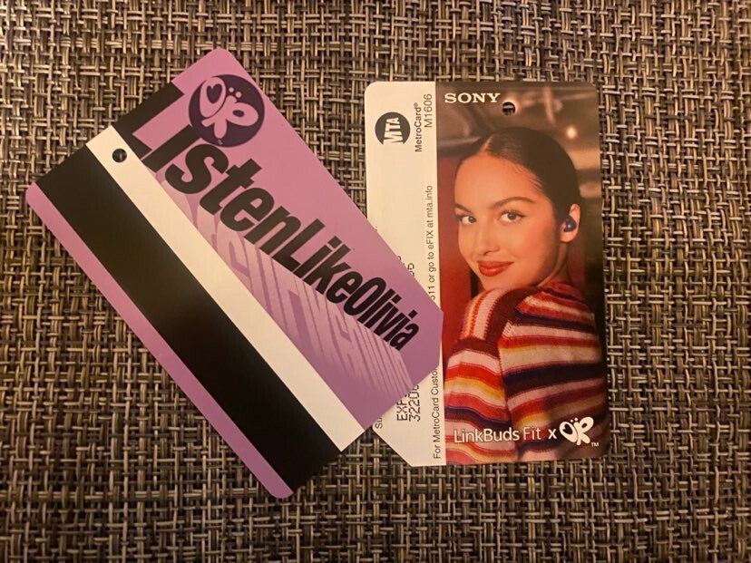 EXPIRED Olivia Rodrigo NYC New York card / wearing her signature violet LinkBuds