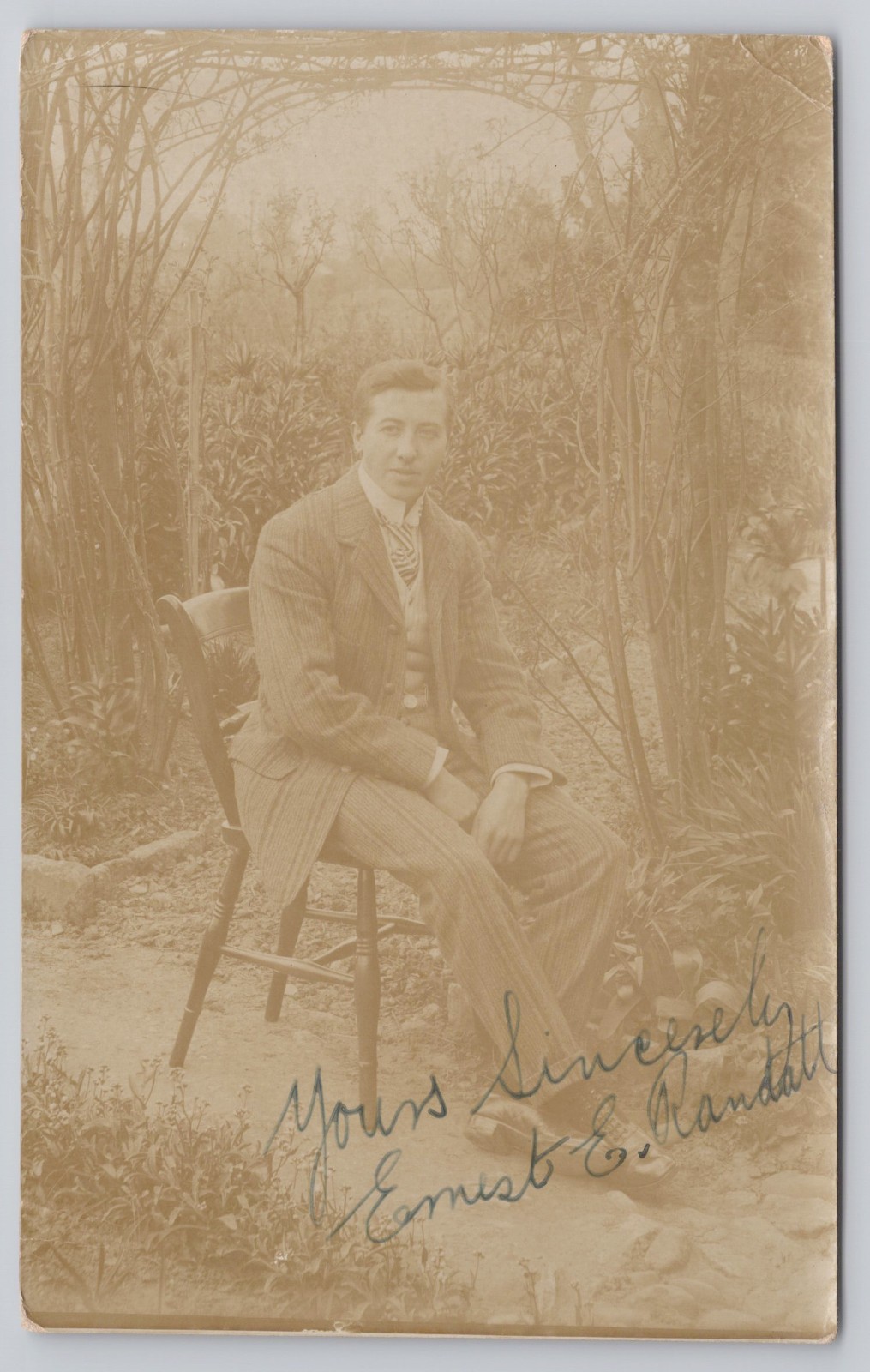 1905 RPPC Young Man Seated in Garden Signed Ernest E. Randall