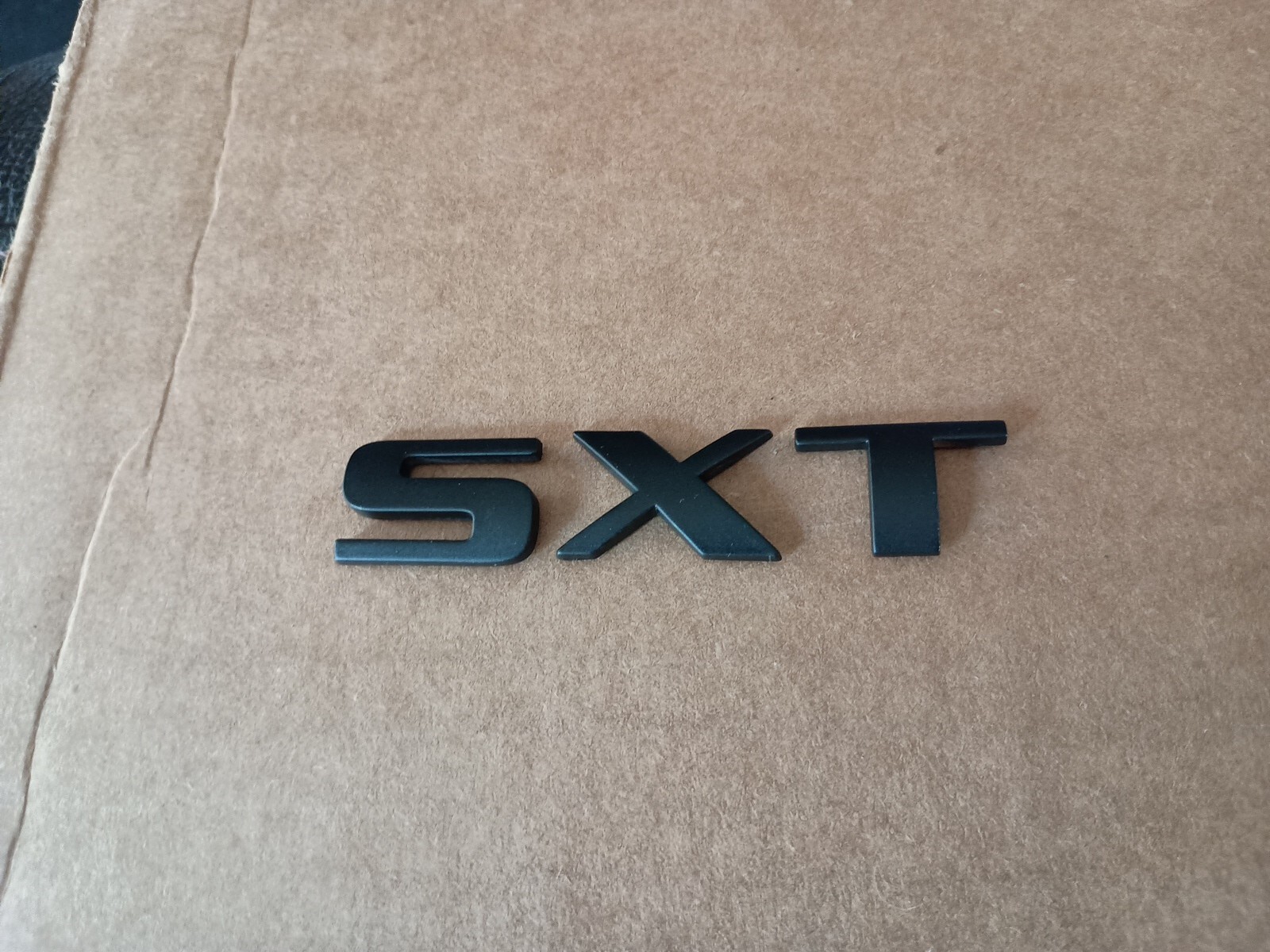 DODGE PAINTED MATTE BLACK SXT EMBLEM OEM USED