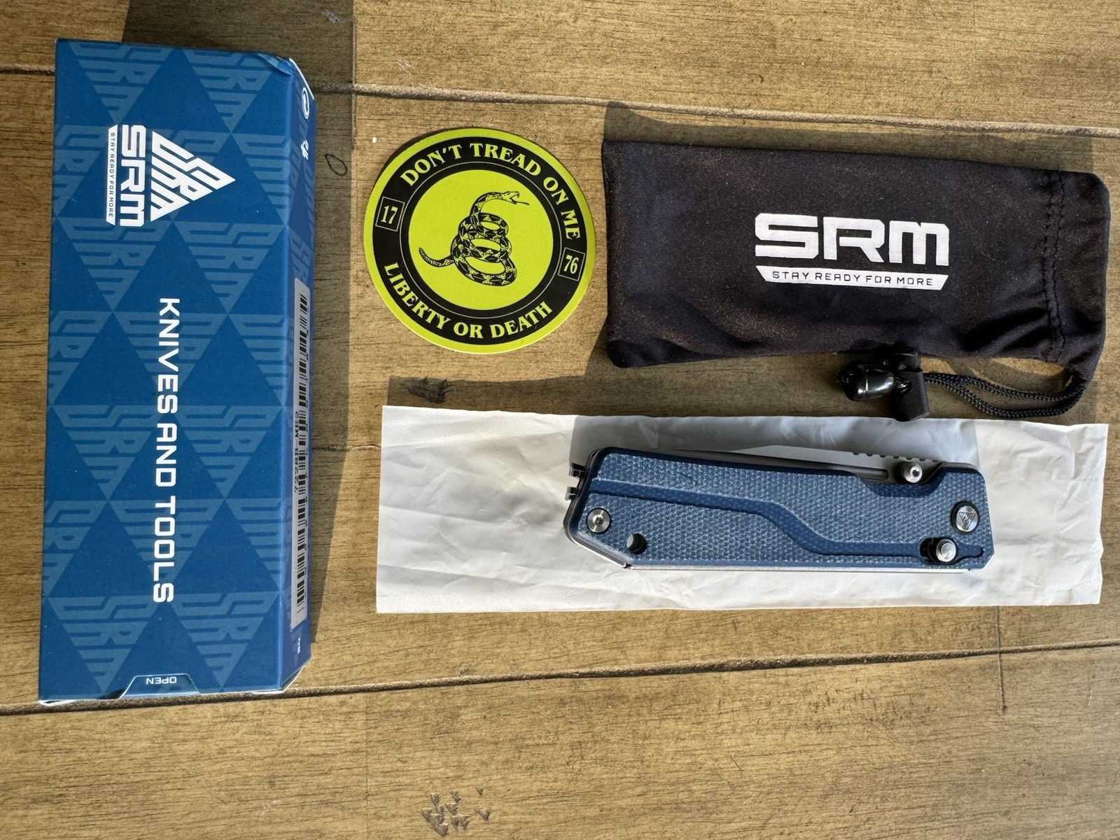 SRM Rubik 3.43″ Laminated 140Cr blade, blue Micarta 25 % off list, Lanyard incl