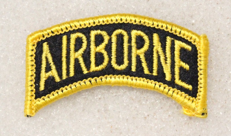 Army patch 5117: “AIRBORNE” tab – yellow on black w/yellow merrowed edge