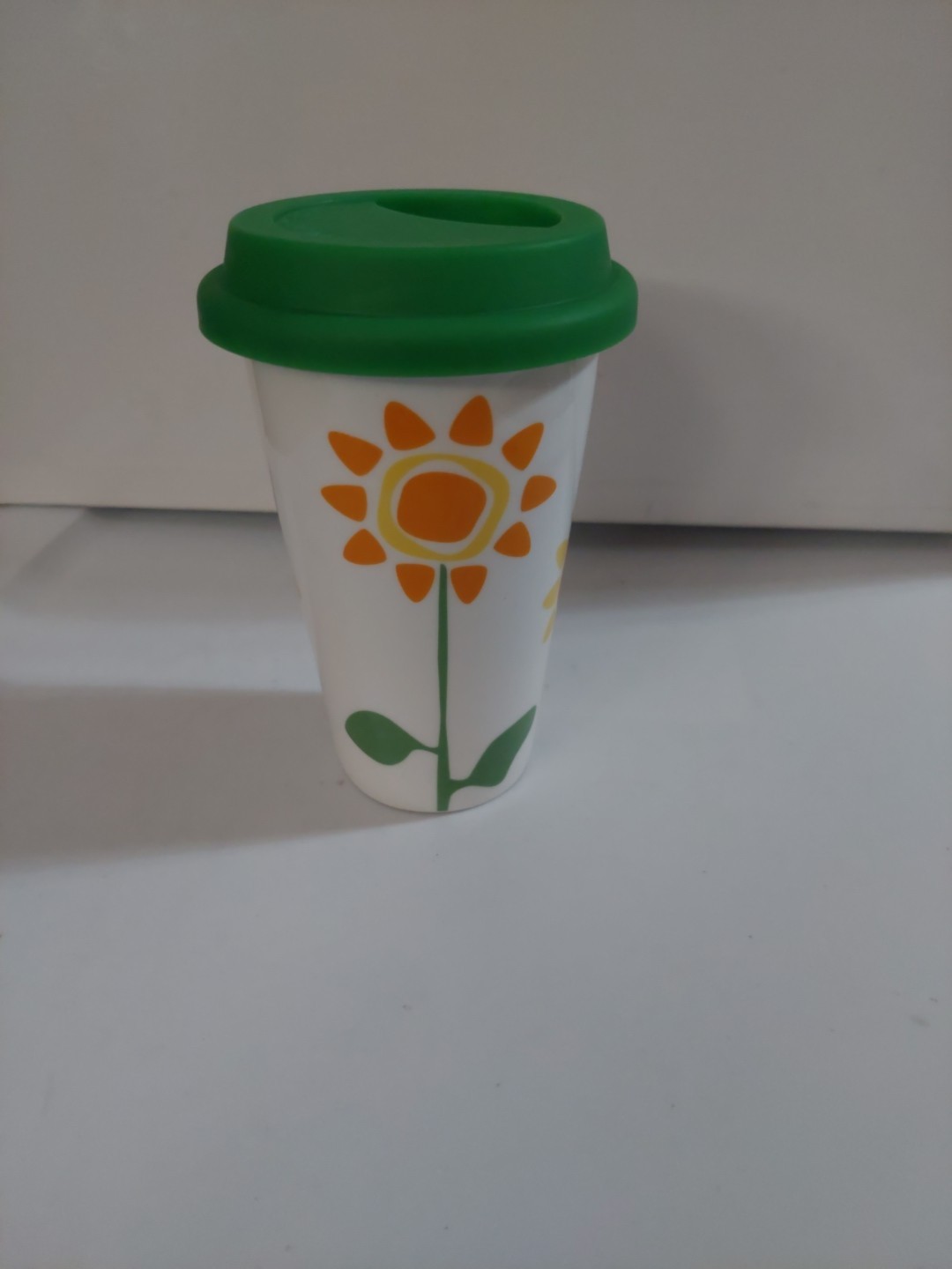 Bright Floral 10 oz Ceramic Travel Mug With Bright Green Silicone Lid