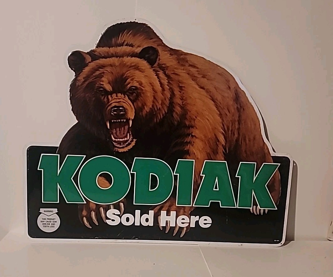 Kodiak Sold Here 20” X 17” Metal Sign. Bent Up Some As Pictures Show Repo