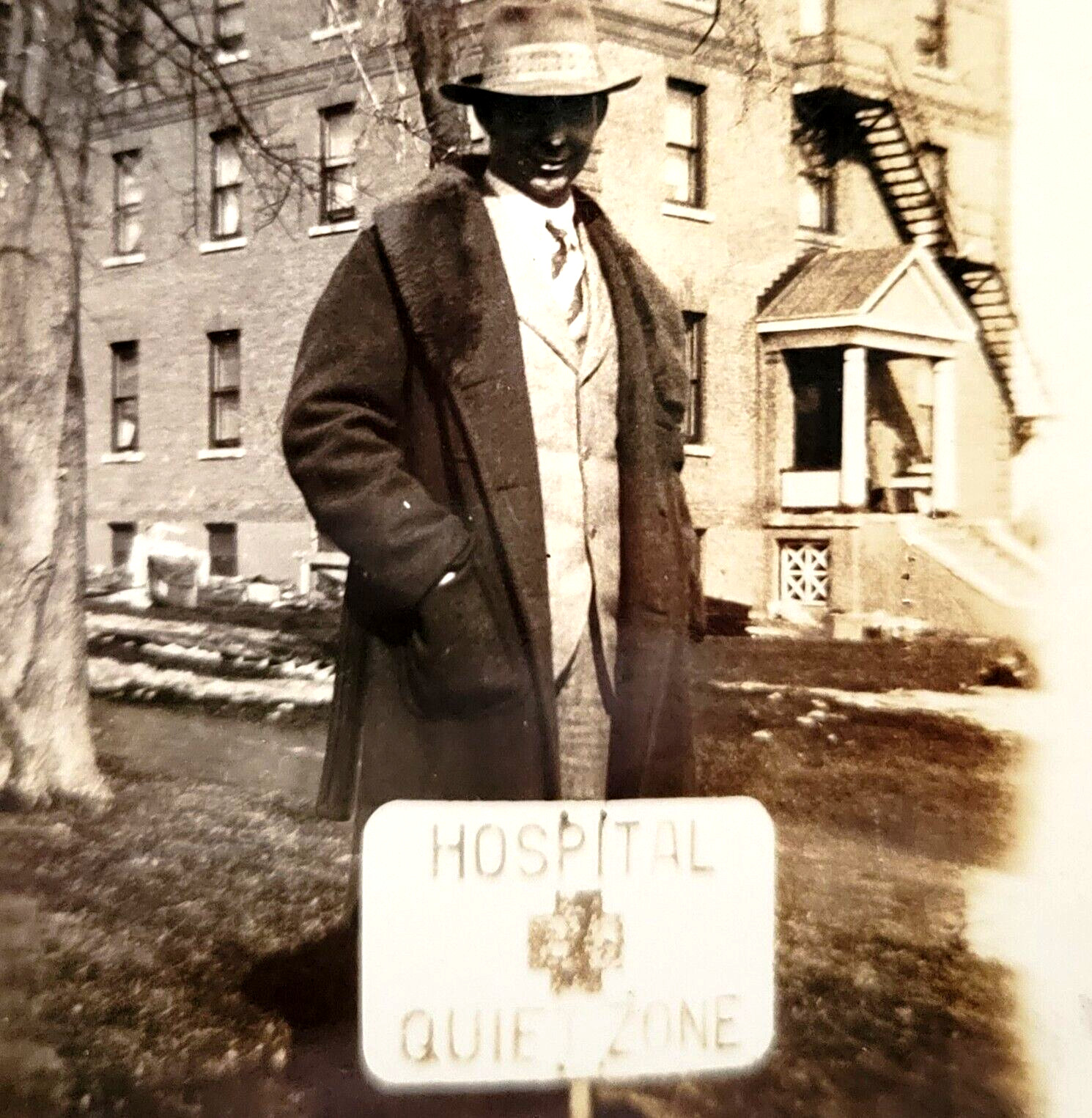1920s Man with Fedora Hat in Back of Hospital Quite Zone Sign Photo