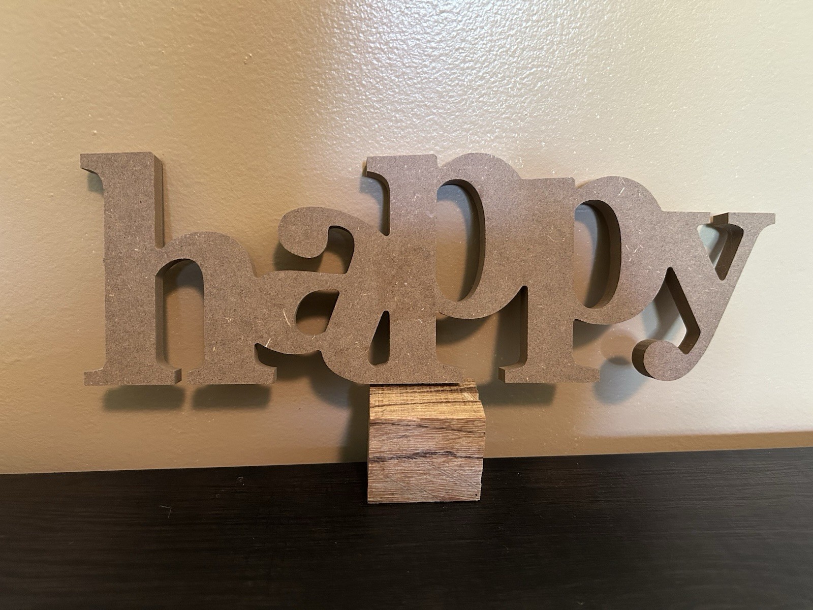 Hanging decorative “happy” wall decor piece. Hooks for hanging.