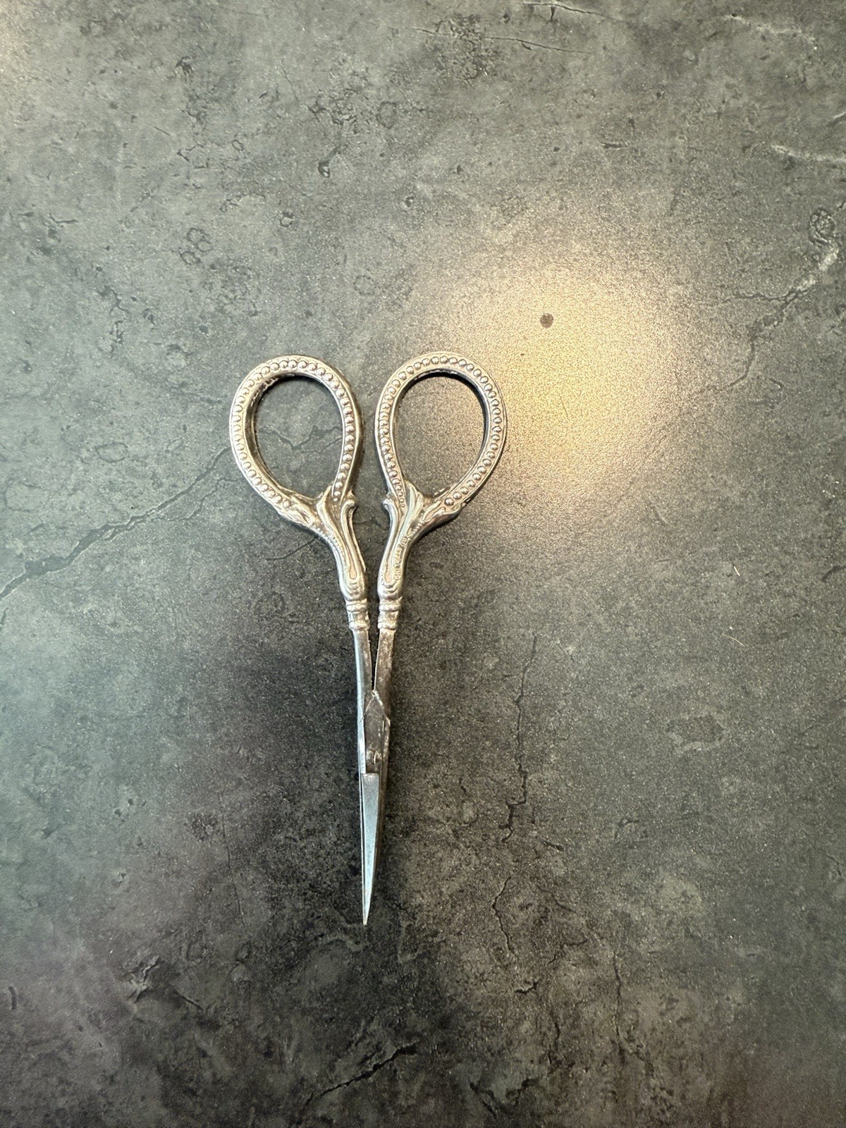 Ornate Sterling Silver metal embroidery scissors with decorative handles.