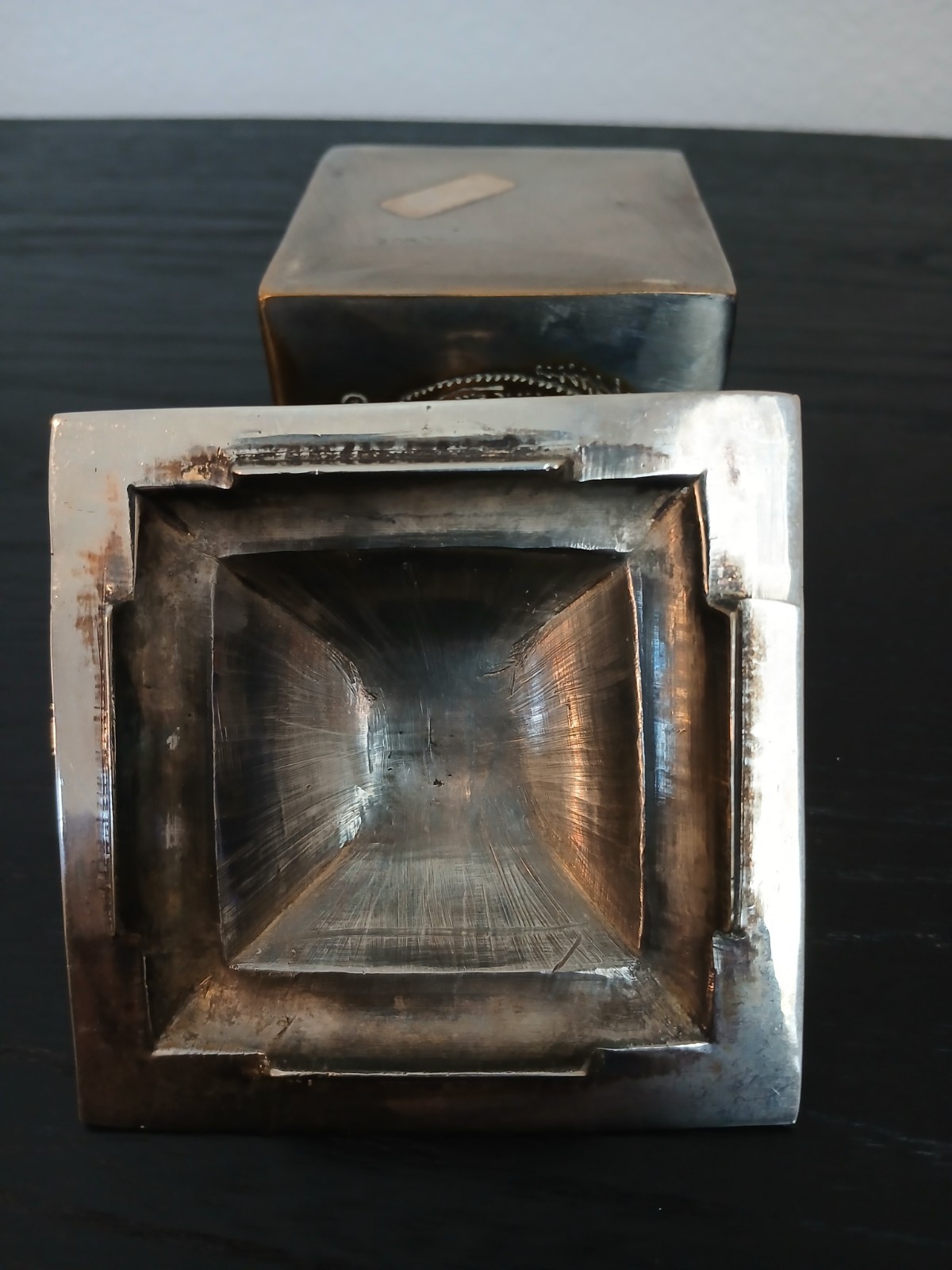 silver-plated trinket box featuring an engraved design and a lid with a knob